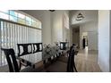 Elegant dining room features a modern table, large windows, and ample natural light at 513 Bailey Cir, Davenport, FL 33897