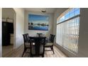 Stylish dining area with modern table and chairs, complemented by a scenic painting at 513 Bailey Cir, Davenport, FL 33897