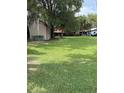 Spacious backyard with lush green grass and mature trees at 524 Florida Ave, St Cloud, FL 34769