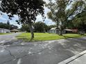 Street view featuring a home with a spacious front lawn and mature trees on a corner lot at 524 Florida Ave, St Cloud, FL 34769