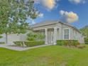 Inviting home with manicured lawn, decorative shrubbery, and a welcoming entrance, creating a warm first impression at 5353 Red Leaf Ct, Oviedo, FL 32765