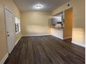 A well-lit living room features wood floors, a breakfast bar, and freshly painted walls at 5821 La Costa Dr # 108, Orlando, FL 32807