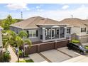 Beautiful exterior elevation of a two-story home with a large driveway and attached garage at 6566 S Goldenrod Rd # 82A, Orlando, FL 32822