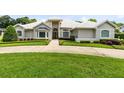 Beautiful home featuring manicured landscaping, expansive lawn, and a circular driveway at 740 Bear Creek Cir, Winter Springs, FL 32708