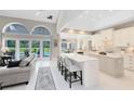 Open-concept kitchen featuring a large center island, seating, and seamless transition into the living area at 740 Bear Creek Cir, Winter Springs, FL 32708