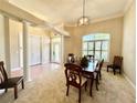 Dining room with high ceilings, a decorative light fixture, columns, and a large window for natural light at 800 Sterling Chase Dr, Port Orange, FL 32128