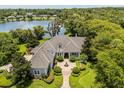 Aerial view of an estate home with well maintained lawn and lush landscaping at 8542 Eden Park Rd, Orlando, FL 32810