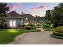 Stately home boasts professional landscaping, brick circular drive and decorative fountain at 8542 Eden Park Rd, Orlando, FL 32810