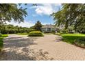 Brick driveway with professionally landscaped circular gardens at 8542 Eden Park Rd, Orlando, FL 32810