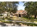Beautiful brick home with well-maintained lawn and mature trees offering plenty of shade at 8800 Torey Pines Ter, Orlando, FL 32819