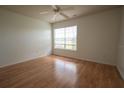 Bright bedroom featuring a ceiling fan, natural light, and wood-look floors, perfect for comfort at 9053 Lee Vista Blvd # 1404, Orlando, FL 32829
