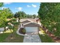 Charming home with stone accents, a two-car garage, and mature trees in a well-kept neighborhood at 10519 Wyndcliff Dr, Orlando, FL 32817