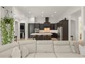 Modern kitchen with dark cabinetry, a center island with seating, stainless steel appliances, and open layout at 11754 Waterstone Loop Dr, Windermere, FL 34786