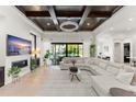 Bright living room featuring a decorative ceiling, a large sectional couch, and sliding glass doors to the backyard at 11754 Waterstone Loop Dr, Windermere, FL 34786