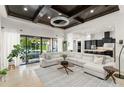 Spacious living room with a large sectional couch, travertine floors, and seamless access to the kitchen and outdoor pool at 11754 Waterstone Loop Dr, Windermere, FL 34786