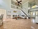 Bright, open living room with high ceilings, a staircase and tile flooring at 1212 Bradwell Dr, Orlando, FL 32837