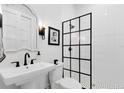 Modern bathroom with sleek black fixtures, a glass-enclosed shower, and elegant tiling at 1410 W New Hampshire St, Orlando, FL 32804