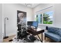 Well-lit home office with a modern desk setup, stylish decor, and a comfortable accent chair at 1410 W New Hampshire St, Orlando, FL 32804