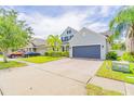 A well-maintained two-story home with brick driveway, lush greenery, and a two-car garage at 1639 Balsam Willow Trl, Orlando, FL 32825