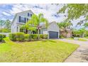 Beautifully landscaped front yard showcasing a two-story home with a spacious two-car garage at 1639 Balsam Willow Trl, Orlando, FL 32825