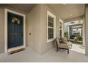 Welcoming front porch with cozy seating, a decorated entrance door, and lots of natural light at 16564 Silversaw Palm Dr, Winter Garden, FL 34787