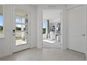 Bright foyer with a view into the home office that has neutral decor and lots of natural light at 2042 Education St, St Cloud, FL 34771