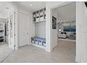 Well-organized mudroom with built-in shelving, bench seating, and stylish decor at 2042 Education St, St Cloud, FL 34771