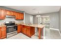 Well-lit kitchen with stainless steel appliances and granite countertops at 2078 Keyes Ln, Deltona, FL 32738