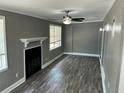 Cozy living room with a decorative fireplace, ceiling fan, and natural light from multiple windows at 2078 Keyes Ln, Deltona, FL 32738