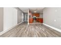 Open-concept living space with hardwood floors, flowing to the kitchen at 2078 Keyes Ln, Deltona, FL 32738