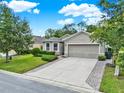 Charming one-story home boasting a two-car garage and meticulously maintained landscaping at 2216 Sequoia Way, Davenport, FL 33896