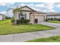 Charming single-story home featuring a well-manicured lawn and attached two-car garage at 3093 Neverland Dr, New Smyrna Beach, FL 32168