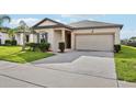 Charming single-story home featuring a well-manicured lawn and attached two-car garage at 3093 Neverland Dr, New Smyrna Beach, FL 32168