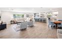 Open-concept living room featuring tile floors, comfortable seating, and view into the kitchen and dining areas at 402 Saint Dunstan Way, Winter Park, FL 32792