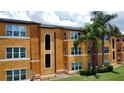 View of the apartment complex with well-maintained grounds and mature palm trees at 4606 Commander Dr # 1126, Orlando, FL 32822