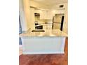 Bright kitchen featuring granite countertops and modern stainless steel refrigerator at 4606 Commander Dr # 1126, Orlando, FL 32822