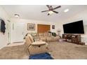 Comfortable living room featuring neutral carpet, ceiling fan, and a large sectional sofa at 468 E Oakwood Ave, Orange City, FL 32763