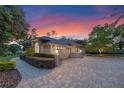 Side angle view of this home highlighting landscaping, outdoor lighting, and the garage entrance at 5102 Round Tree Ct, Orlando, FL 32819