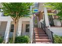Charming front entrance with brick steps, mature tree, and inviting front door at 528 Lanark Ct, Orlando, FL 32806