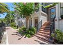 Charming townhome exterior with brick walkway, front door, and lush landscaping at 528 Lanark Ct, Orlando, FL 32806