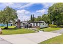 Landscaped front yard with a well manicured lawn leading to a lovely home featuring a brick chimney at 608 Cedar Ave, Holly Hill, FL 32117