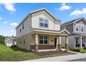 Beautiful two-story home with a cozy front porch and lush green lawn in a residential neighborhood at 6449 Sprucepine Ln, St Cloud, FL 34771