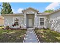 Inviting front entrance with a walkway and beautiful landscaping at 702 Pasteur Ln, Kissimmee, FL 34759