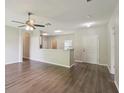 Spacious living room with modern wood-look flooring and a ceiling fan at 702 Pasteur Ln, Kissimmee, FL 34759