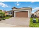 Spacious paved driveway leading to the garage of a well-maintained single-story home at 911 Tidal Pond Dr, Groveland, FL 34736