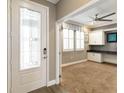 Inviting entryway featuring a decorative glass door and a view into a home office at 911 Tidal Pond Dr, Groveland, FL 34736