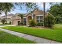Inviting front exterior of home with landscaped lawn and an attached two-car garage at 9650 Bay Pine Ln, Orlando, FL 32832