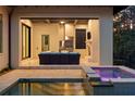 Beautiful pool and jacuzzi area with an outdoor living space with a tv and grill at 10143 Mattraw Pl, Golden Oak, FL 32836