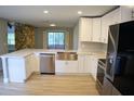 Modern kitchen with stainless steel appliances, custom cabinets, and quartz countertops at 1102 Winter Springs Blvd, Winter Springs, FL 32708
