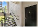 A staircase leading to the unit, providing access to the upper levels of the building at 12843 Madison Pointe # 208, Orlando, FL 32821